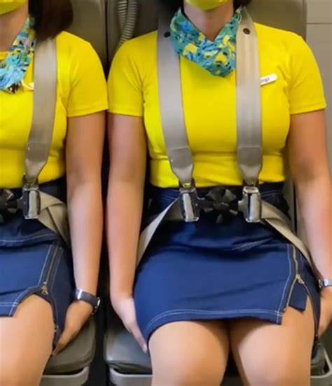 Scary reason why flight attendants sit on their hands during flight