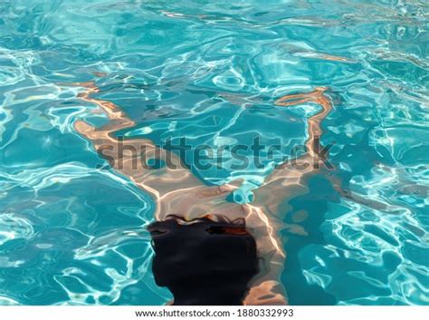 Naked woman outdoors. Beautiful young nude woman in swimming pool.