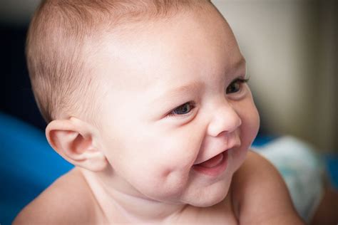 ''The adorable dimples and delightful smile of the newborn infant ...