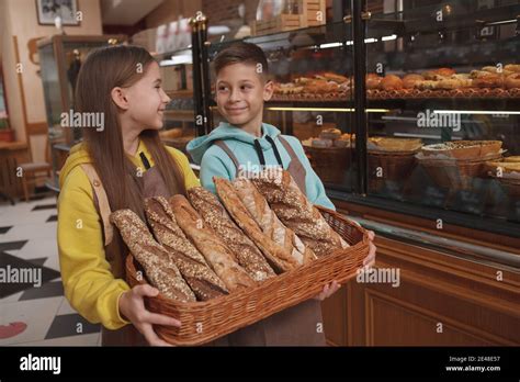 charming  kids bakers selling delicious bread   family