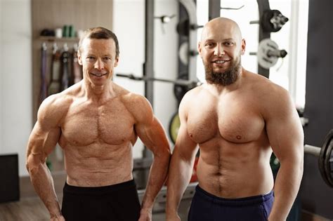 Premium Photo | Two shirtless men standing in gym young man and his