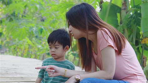 Asian mother and son happily play with toys in the park 2461458 Stock