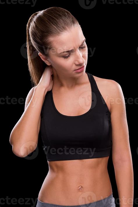 Pain in muscles. Frustrated young woman touching her neck and keeping