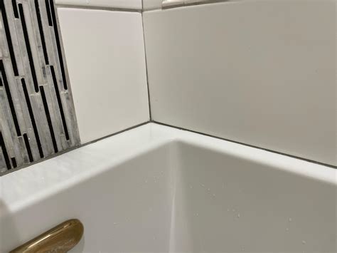 Should I caulk between tub and tile if there is grout? : r/Tile