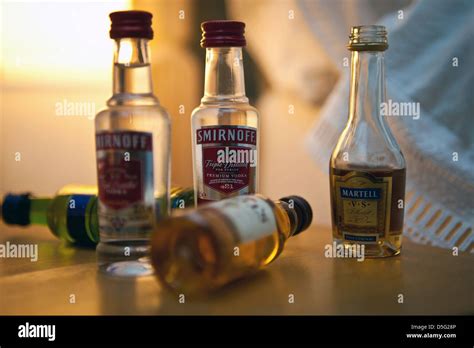 Miniature bottles of alcoholic drinks from hotel mini-bar on bedside ...