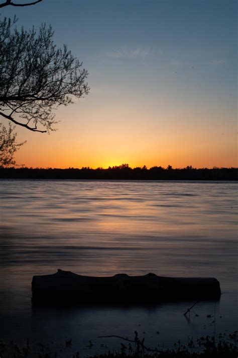 stock photo  sunset   calm lake reflecting stunning colors
