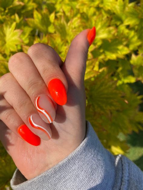 Bright Orange Nails With White Swirls Design Idea – Vibrant Guide