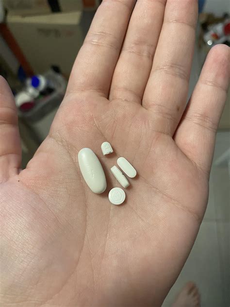 The size of my painkiller with my other meds and hand for scale :) : r