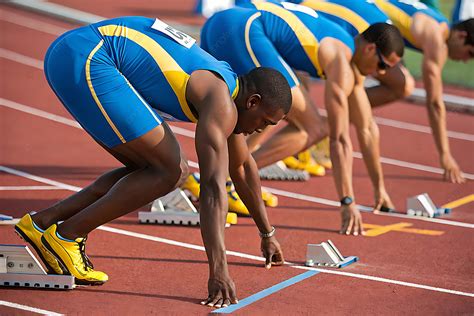 Sprinters In Blue And Yellow Uniforms Ready To Race Background, Track