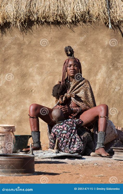 Namibia, Africa, Himba Village, July 18, 2019: a Himba Woman Sits ...