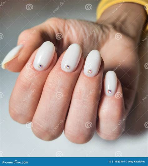 Gentle Gel Polish of Milky Color on Short Nails with Sequins and