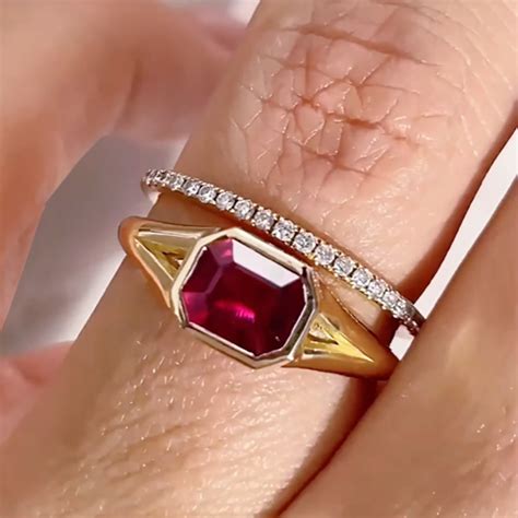 ruby emerald cut east west bezel set solitaire modern engagement ring