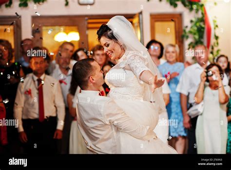Fantastic wedding couple dancing their first dance in the restaurant ...
