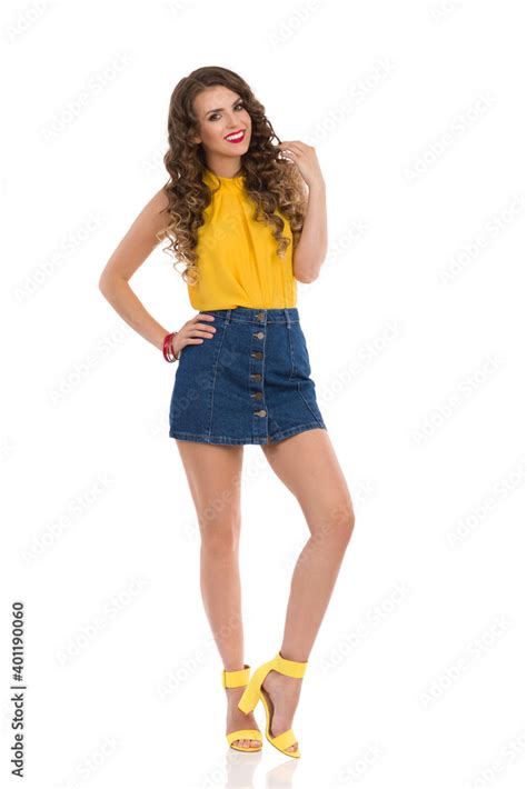 Fashion Model In Jeans Mini Skirt And High Heels Is Posing With Hand On ...