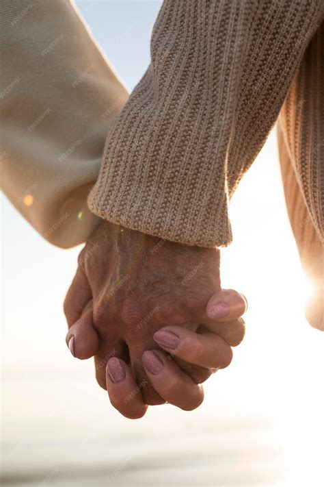 premium photo close   couple holding hands