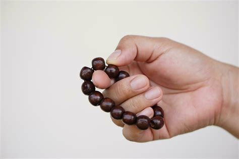 close  hand holds beads bracelet counting   meditation