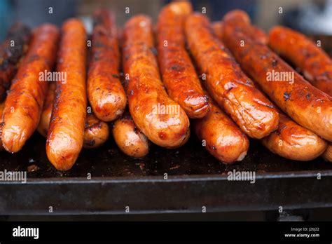 Cooked long hot dog sausages on a grill Stock Photo - Alamy