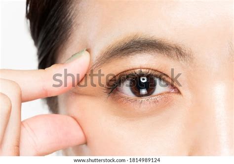 woman picking corner  eye stock photo edit