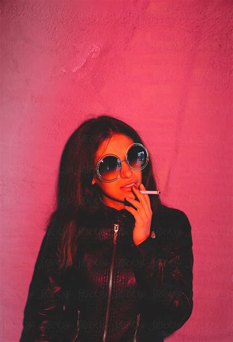 "Young Latin American Woman Smoking" by Stocksy Contributor "Alexey