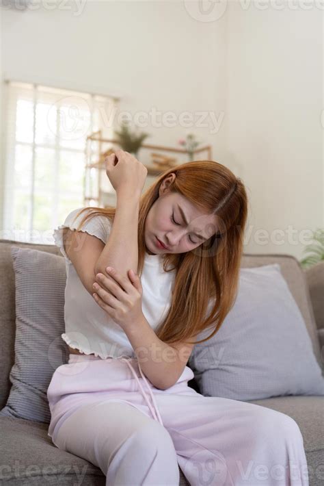 Asian woman have elbow pain, inflammation of tendon or ligament injury