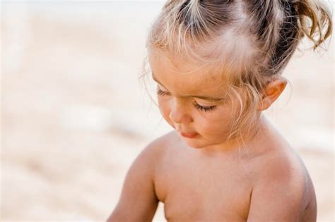 Premium Photo | Close-up of shirtless girl sitting at beach