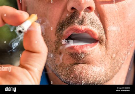 close    man smoking cigarette stock photo alamy