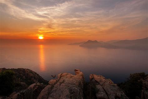 Sunset over the Calanques de Piana Photograph by Thierry Baudin