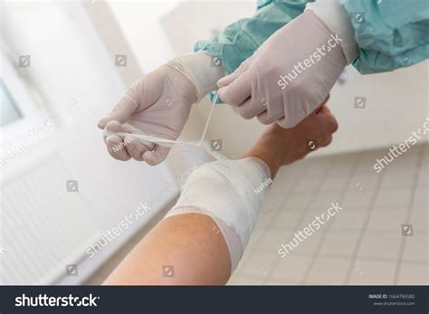 doctor puts  pressure bandage hospital stock photo