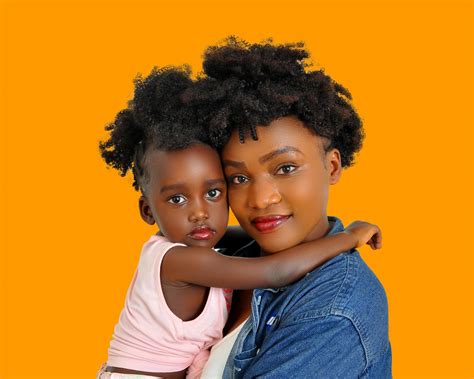 Charming black mother with daughter on hands · Free Stock Photo