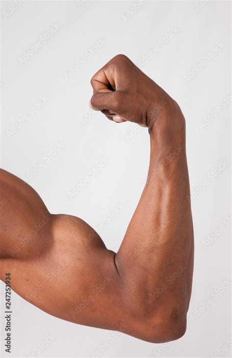 Strong Black man flexing muscles Stock Photo | Adobe Stock