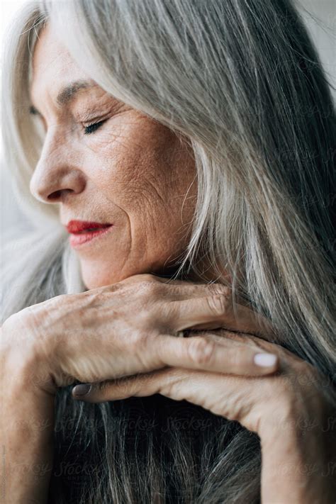 "Closeup Portrait Of An Attractive Senior Woman With Grey Long Hair