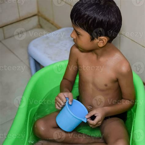 Cute Indian Boy having bath during the summer vacation season, Cute