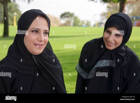 Arab Mother and Daughter Smiling Together on Grass in Park Stock Photo ...
