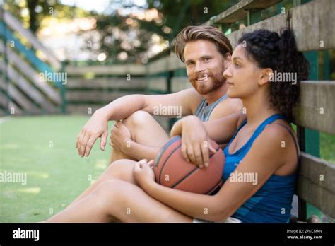 couple having a break after match Stock Photo - Alamy