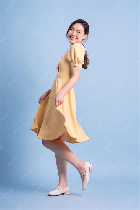 Premium Photo | Beautiful young asian woman dancing on blue background