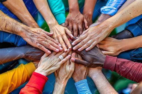 Hands of diverse people coming together in unity teamwork and community ...