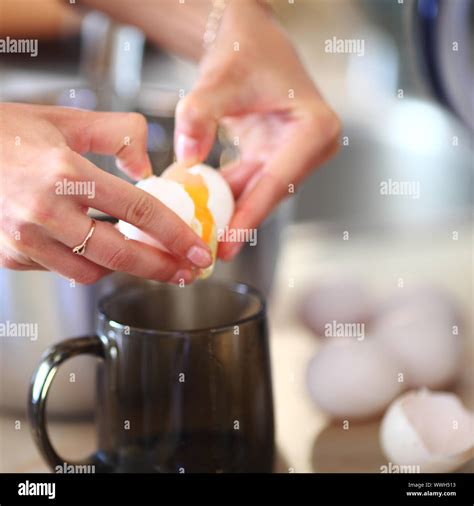 break an egg by cup Stock Photo - Alamy