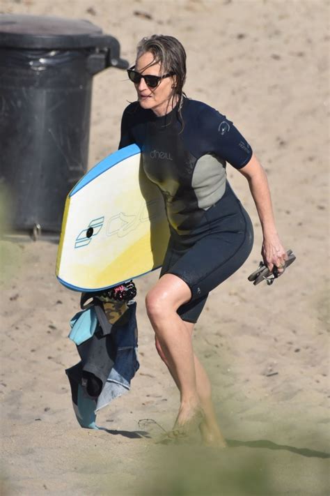 HELEN HUNT in Wetsuit at Bodyboarding Session in Malibu 06/26/2020