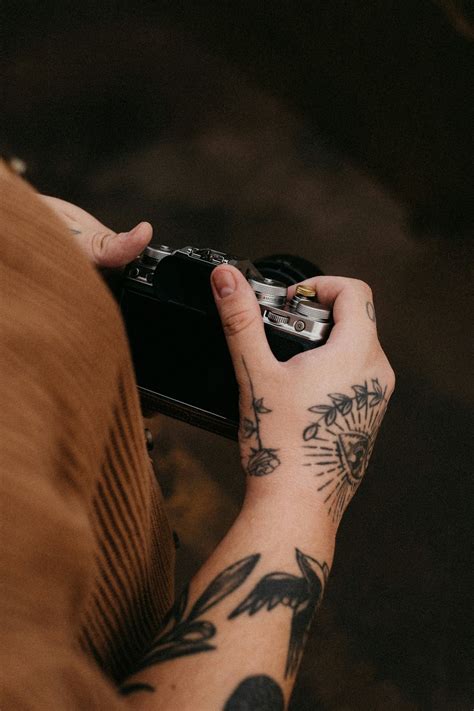 person   tattoo holding  camera photo  brasil image