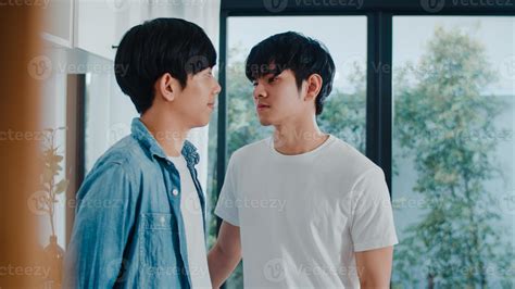 Asian Gay couple standing and hugging room at home. Young handsome
