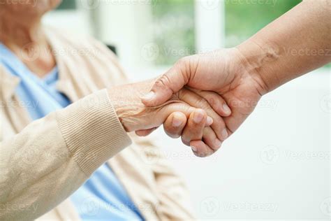 Doctor holding hands Asian elderly woman patient, help and care in