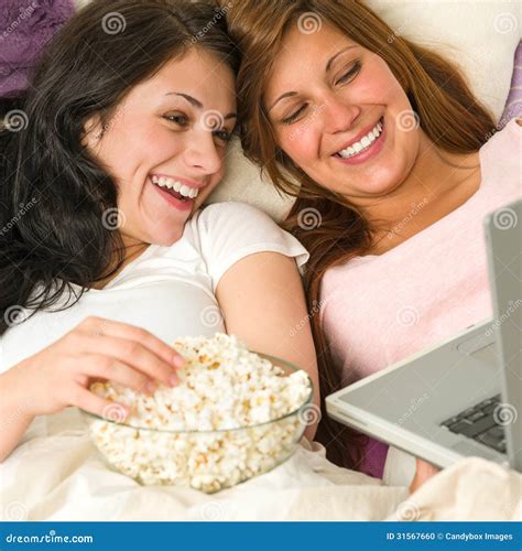 Sisters Lying on Bed Watching Funny Movie Stock Photo - Image of laptop