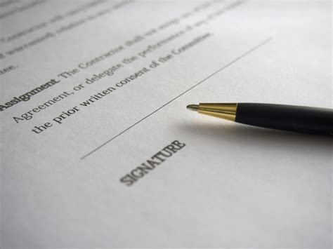 person signing  documentation paper  stock photo