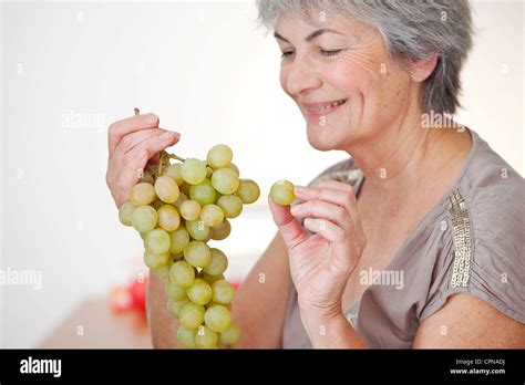 ELDERLY PERSON EATING FRUIT Stock Photo - Alamy