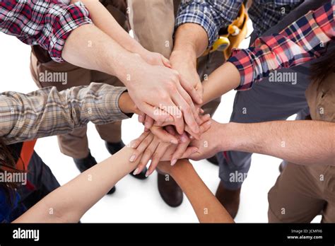 Large group of construction worker stacking hands. Isolated on white ... 