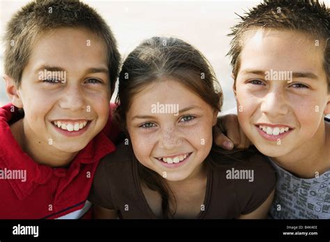 hispanic twin brothers  sister hugging stock photo alamy