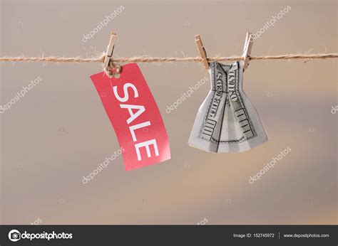 sale sign  dollar banknote  clothesline stock photo