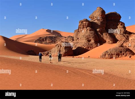 Algeria, Sahara, Tassili N'Ajjer National Park, Tadrart, people hiking ...