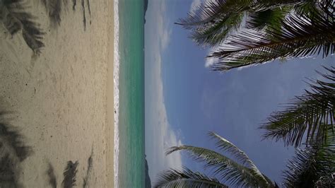 Vertical video pov ocean sand beach and water surface texture. Foamy