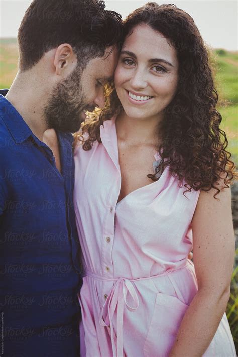 "Young Couple Together Outside Laughing And Hugging In Nature." by